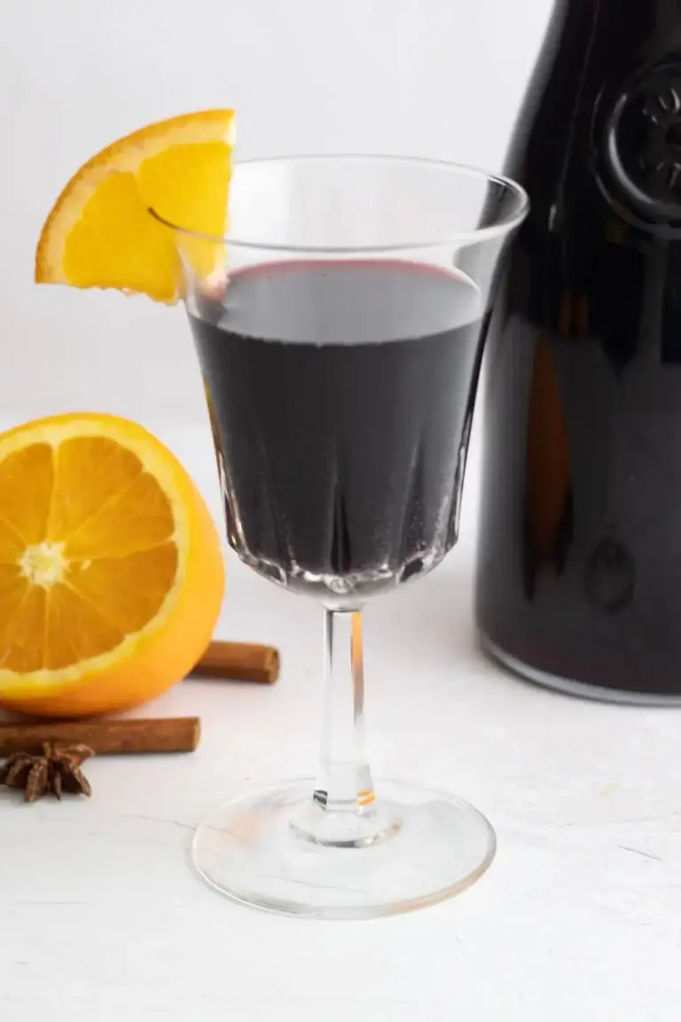 Red wine cocktail with a an orange garnish