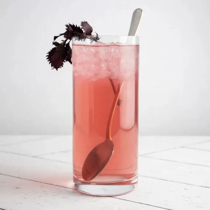 glass of shiso juice with red perilla leaf garnish