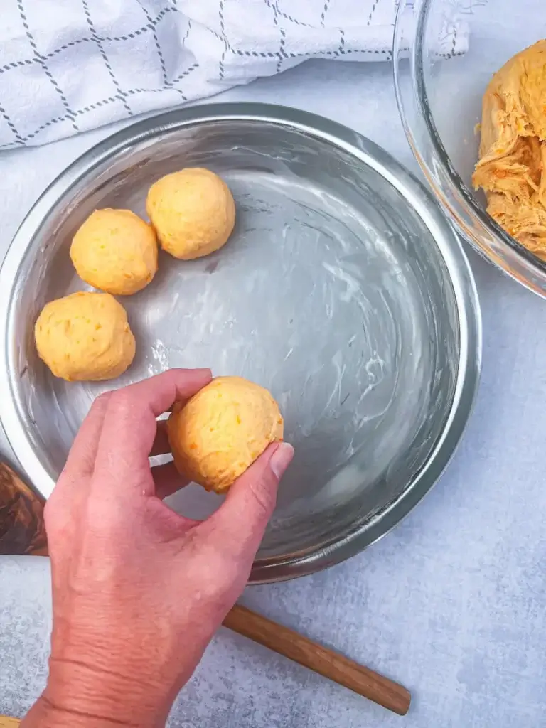 shaping sweet potato rolls and putting them in a circular baking pan