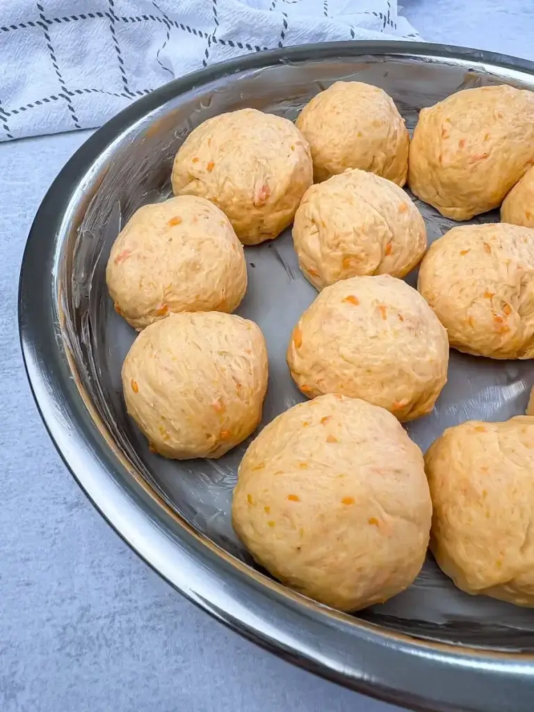 a dozen sweet potato rolls shaped in a circular pan ready to bake