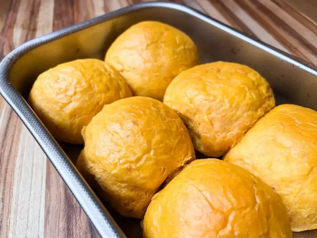 fresh from the oven sweet potato buns in a rectangular baking pan